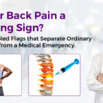 Doctor examining patient's spine for back pain warning signs in Gurgaon clinic
